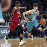 
              Charlotte Hornets guard LaMelo Ball (2) drives to the basket while guarded by Miami Heat forward Jimmy Butler (22) during the first half of an NBA basketball game in Charlotte, N.C., Saturday, Feb. 5, 2022. (AP Photo/Jacob Kupferman)
            