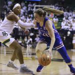 
              Kansas guard Julie Brosseau, right, drives on Baylor guard Sarah Andrews, left, in the first half of an NCAA college basketball game, Saturday, Feb. 26, 2022, in Waco, Texas. (AP Photo/Rod Aydelotte)
            