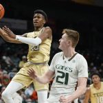 
              Georgia Tech guard Miles Kelly, left, goes up for a shot against Miami forward Sam Waardenburg (21) during the first half of an NCAA college basketball game, Wednesday, Feb. 9, 2022, in Coral Gables, Fla. (AP Photo/Wilfredo Lee)
            