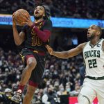 
              Cleveland Cavaliers' Darius Garland (10) drives to the basket past Milwaukee Bucks' Khris Middleton (22) in the second half of an NBA basketball game, Wednesday, Jan. 26, 2022, in Cleveland. The Cavaliers won 115-99. (AP Photo/Tony Dejak)
            