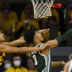 
              Michigan State guard Jaden Akins (3) drives to the basket ahead of Iowa forward Kris Murray, left, during the second half of an NCAA college basketball game, Tuesday, Feb. 22, 2022, in Iowa City, Iowa. (AP Photo/Charlie Neibergall)
            