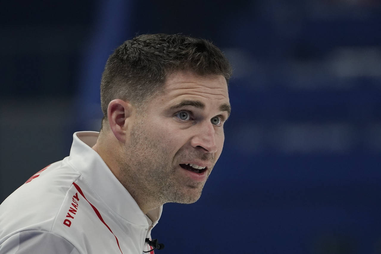 John Morris, of Canada, reacts after being told he didn't wipe his stone during the mixed doubles c...