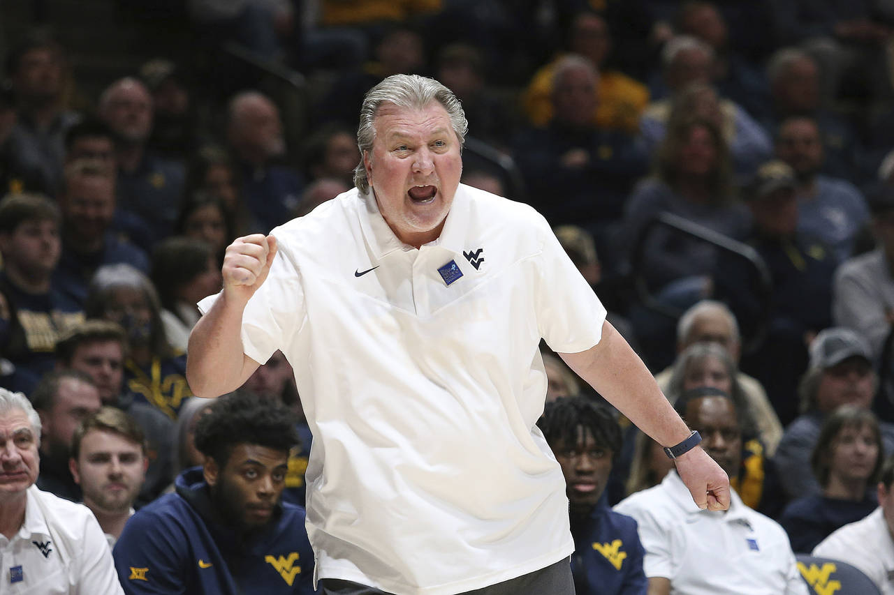 West Virginia coach Bob Huggins reacts during the first half of an NCAA college basketball game aga...
