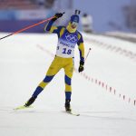 
              Martin Ponsiluoma of Sweden crosses the finish line in the men's 15-kilometer mass start biathlon at the 2022 Winter Olympics, Friday, Feb. 18, 2022, in Zhangjiakou, China. (AP Photo/Kirsty Wigglesworth)
            