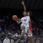 
              LSU guard Eric Gaines (2) drives past Mississippi forward Jaemyn Brakefield during the second half of an NCAA college basketball game in Baton Rouge, La., Tuesday, Feb. 1, 2022. (AP Photo/Matthew Hinton)
            