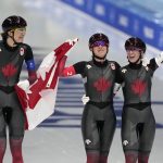 
              Team Canada's Isabelle Weidemann, left, Valerie Maltais and Ivanie Blondin, right, celebrate after they won the gold medal and set an Olympic record in the speedskating women's team pursuit finals at the 2022 Winter Olympics, Tuesday, Feb. 15, 2022, in Beijing. (AP Photo/Ashley Landis)
            