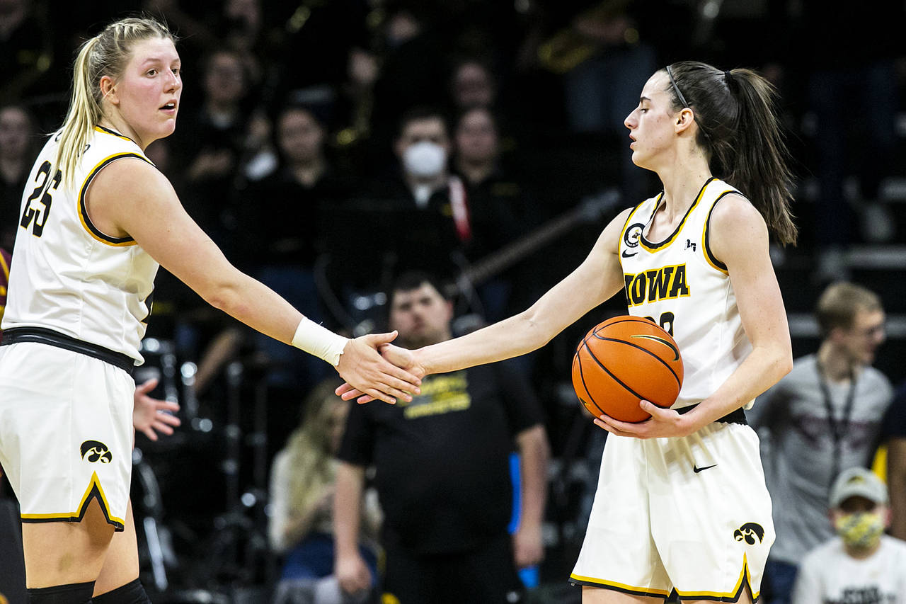 Iowa guard Caitlin Clark, right, gets a high-five from center Monika Czinano during the team's NCAA...