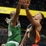 
              Orlando Magic guard Jalen Suggs, right, tries to get off a shot over Boston Celtics forward Al Horford, left, during the first half of an NBA basketball game, Sunday, Feb. 6, 2022, in Orlando, Fla. (AP Photo/John Raoux)
            