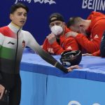 
              Shaolin Sandor Liu, left, of Hungary, reacts after he was disqualified in the final of the men's 1,000-meter during the short track speedskating competition at the 2022 Winter Olympics, Monday, Feb. 7, 2022, in Beijing. (AP Photo/Natacha Pisarenko)
            