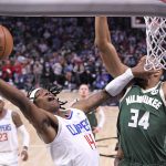 
              Los Angeles Clippers guard Terance Mann, left, shoots as Milwaukee Bucks forward Giannis Antetokounmpo defends during the second half of an NBA basketball game Sunday, Feb. 6, 2022, in Los Angeles. (AP Photo/Mark J. Terrill)
            