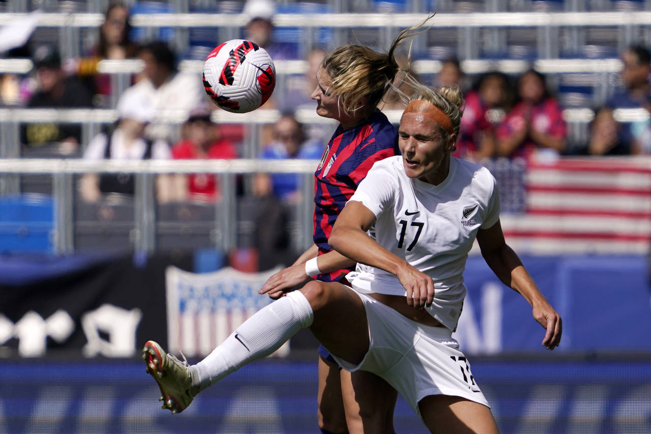 United States defender Emily Fox, left, and New Zealand forward Hannah Wilkinson try to head the ba...