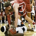 
              Oklahoma forward Tanner Groves (35) reaches for the ball being held by Oklahoma State forward Moussa Cisse (33) in the first half of an NCAA college basketball game Saturday, Feb. 5, 2022, in Stillwater, Okla. (AP Photo/Brody Schmidt)
            