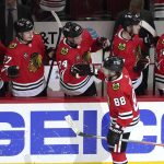 
              Chicago Blackhawks' Patrick Kane (88) celebrates his goal with teammates during the second period of an NHL hockey game against the New Jersey Devils, Friday, Feb. 25, 2022, in Chicago. (AP Photo/Charles Rex Arbogast)
            