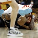 
              Washington forward Emmitt Matthews Jr., bottom right, holds on to the ball as he and Southern California guard Reese Dixon-Waters went to the floor during the first half of an NCAA college basketball game in Los Angeles, Thursday, Feb. 17, 2022. (AP Photo/Alex Gallardo)
            