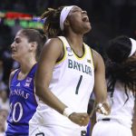 
              Baylor forward NaLyssa Smith reacts to a foul as Kansas guard Julie Brosseau, left, looks to the basket in the second half of an NCAA college basketball game, Saturday, Feb. 26, 2022, in Waco, Texas. (AP Photo/Rod Aydelotte)
            