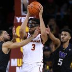 
              Southern California forward Isaiah Mobley, center, looks to pass the ball as Washington guards Terrell Brown Jr., left, and Jamal Bey defend during the first half of an NCAA college basketball game in Los Angeles, Thursday, Feb. 17, 2022. (AP Photo/Alex Gallardo)
            