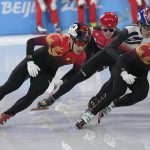 
              Ren Ziwei of China, left, and Li Wenlong, right, race in his semifinal of the men's 1,000-meter during the short track speedskating competition at the 2022 Winter Olympics, Monday, Feb. 7, 2022, in Beijing. (AP Photo/David J. Phillip)
            