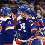
              New York Islanders players celebrate after a goal by New York Islanders' Mathew Barzal (13) against the Ottawa Senators during the second period of an NHL hockey game Tuesday, Feb. 1, 2022, in Elmont, N.Y. (AP Photo/Jason DeCrow)
            