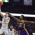 
              Kentucky's Kellan Grady (31) shoots while defended by LSU's Tari Eason (13) during the second half of an NCAA college basketball game in Lexington, Ky., Wednesday, Feb. 23, 2022. (AP Photo/James Crisp)
            