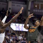 
              Oklahoma State guard Avery Anderson III (0) attempts to shoot the ball over TCU guard Damion Baugh (10) in the first half of an NCAA college basketball game in Fort Worth, Texas, Tuesday, Feb. 8, 2022. (AP Photo/Emil Lippe)
            