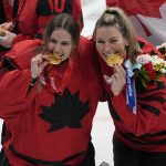 
              Canada goalkeeper Emerance Maschmeyer and Natalie Spooner, right, pose with their gold medals after defeating the United States in during the women's gold medal hockey game at the 2022 Winter Olympics, Thursday, Feb. 17, 2022, in Beijing. (AP Photo/Jae C. Hong)
            