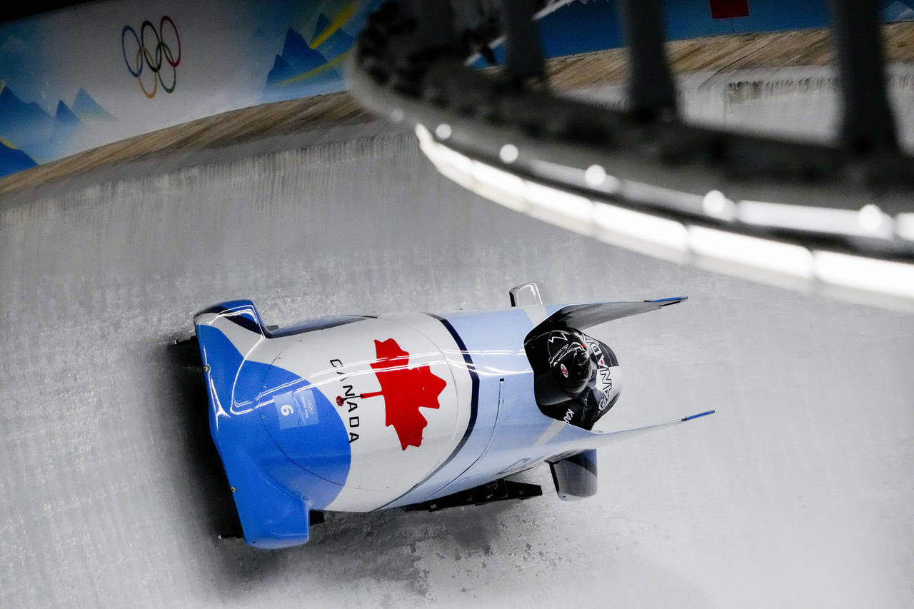 Christine De Bruin and Kristen Bujnowski, of Canada, slide during the women's bobsleigh heat 3 at t...