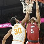 
              Arkansas guard Au'Diese Toney (5) is fouled by Tennessee guard Josiah-Jordan James (30) as he drives to the hoop during the first half of an NCAA college basketball game Saturday, Feb. 19, 2022, in Fayetteville, Ark. (AP Photo/Michael Woods)
            