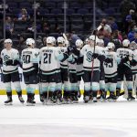 
              The Seattle Kraken celebrate after defeating the New York Islanders in an NHL hockey game Wednesday, Feb. 2, 2022, in Elmont, N.Y. The Kraken won 3-0. (AP Photo/Adam Hunger)
            