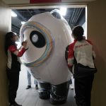 
              Bing Dwen Dwen, the mascot of the Olympics, turns sideways to exit through the doors after visiting the Xinhua news agency's office at the 2022 Winter Olympics, Feb. 8, 2022, in Beijing. (AP Photo/Jae C. Hong)
            