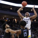 
              Marquette's Justin Lewis (10) shoots after being fouled by Villanova's Jordan Longino (15) during the first half of an NCAA college basketball game Wednesday, Feb. 2, 2022, in Milwaukee. (AP Photo/Aaron Gash)
            