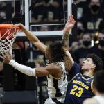
              Purdue guard Jaden Ivey (23) dunks against Michigan forward Brandon Johns Jr. (23) during the first half of an NCAA college basketball game, Saturday, Feb. 5, 2022, in West Lafayette, Ind. (AP Photo/Darron Cummings)
            