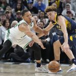 
              Indiana Pacers guard Chris Duarte (3) is defended by Boston Celtics forward Grant Williams, left, during the second half of an NBA basketball game, Sunday, Feb. 27, 2022, in Indianapolis. (AP Photo/Darron Cummings)
            