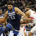 
              Minnesota Timberwolves center Karl-Anthony Towns (32) drives on Toronto Raptors center Khem Birch (24) during the first half of an NBA basketball game Wednesday, Feb. 16, 2022, in Minneapolis. (AP Photo/Andy Clayton-King)
            