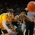 
              Iowa forward Filip Rebraca, left, fights for a loose ball with Michigan State guard A.J. Hoggard during the second half of an NCAA college basketball game, Tuesday, Feb. 22, 2022, in Iowa City, Iowa. (AP Photo/Charlie Neibergall)
            