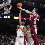 
              Washington State forward Andrej Jakimovski (23) grabs a rebound over Southern California guard Reese Dixon-Waters (21) during the first half of an NCAA college basketball game Sunday, Feb. 20, 2022, in Los Angeles. (AP Photo/Marcio Jose Sanchez)
            