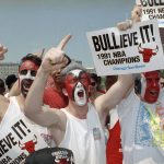 
              FILE - Chicago Bulls fans Rob Martinez, left, Mark Kojak and Michael Kojak, right, show their support for the team during a rally in Chicago, June 14, 1991, celebrating the Bulls NBA championship. (AP Photo/Mark Elias, File)
            