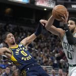 
              Boston Celtics forward Jayson Tatum, right, is called for a foul against Indiana Pacers guard Tyrese Haliburton, left, during the second half of an NBA basketball game, Sunday, Feb. 27, 2022, in Indianapolis. (AP Photo/Darron Cummings)
            