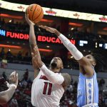 
              Louisville guard Mason Faulkner (11) shoots over North Carolina guard Caleb Love (2) during the second half of an NCAA college basketball game in Louisville, Ky., Tuesday, Feb. 1, 2022. North Carolina won 90-83. (AP Photo/Timothy D. Easley)
            