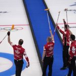 
              Team Canada celebrates after winning the men's curling bronze medal match against the United States at the Beijing Winter Olympics Friday, Feb. 18, 2022, in Beijing. (AP Photo/Nariman El-Mofty)
            