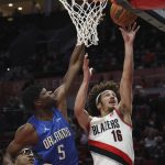
              Portland Trail Blazers guard CJ Elleby, right, drives to the basket as Orlando Magic center Mo Bamba defends during the first half of an NBA basketball game in Portland, Ore., Tuesday, Feb. 8, 2022. (AP Photo/Steve Dipaola)
            