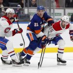 
              Ryan Poehling (25) and Michael Pezzetta (55) of the Montreal Canadiens watch the puck as they defend against Kyle Palmieri (21 of the New York Islanders during the second period at UBS Arena on Sunday, Feb. 20, 2022 in Elmont, N.Y. (Jim McIsaac/Newsday via AP)
            