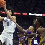 
              Kentucky's Jacob Toppin (0) shoots while defended by LSU's Xavier Pinson, middle, and Tari Eason, right, during the first half of an NCAA college basketball game in Lexington, Ky., Wednesday, Feb. 23, 2022. (AP Photo/James Crisp)
            