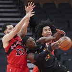 
              Miami Heat center Bam Adebayo (13) vies for the ball against Toronto Raptors guard Fred VanVleet (23) and forward Justin Champagnie (11) during the first half of an NBA basketball game Tuesday, Feb. 1, 2022, in Toronto. (Nathan Denette/The Canadian Press via AP)
            