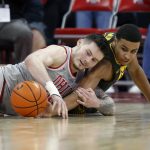
              Ohio State forward Kyle Young, left, works for a loose ball against Iowa forward Keegan Murray during the first half of an NCAA college basketball game in Columbus, Ohio, Saturday, Feb. 19, 2022. (AP Photo/Paul Vernon)
            