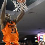 
              Oklahoma State forward Moussa Cisse (33) dunks in front of Oklahoma forward Tanner Groves, right, in the first half of an NCAA college basketball game Saturday, Feb. 26, 2022, in Norman, Okla. (AP Photo/Sue Ogrocki)
            