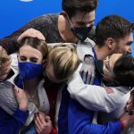 
              Gabriella Papadakis and Guillaume Cizeron, of France, are congratulated by fellow competitors after winning the gold medal in the ice dance competition during the figure skating at the 2022 Winter Olympics, Monday, Feb. 14, 2022, in Beijing. (AP Photo/Bernat Armangue)
            