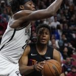 
              Miami Heat guard Kyle Lowry, right, goes up for a shot against Brooklyn Nets center Day'Ron Sharpe during the second half of an NBA basketball game, Saturday, Feb. 12, 2022, in Miami. (AP Photo/Wilfredo Lee)
            