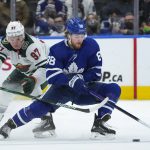 
              Toronto Maple Leafs forward William Nylander (88) cuts past Minnesota Wild forward Kirill Kaprizov (97) during the third period of an NHL hockey game Thursday, Feb. 24, 2022, in Toronto. (Nathan Denette/The Canadian Press via AP)
            