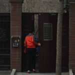 
              A woman enters the North Korean Embassy compound in Beijing, Thursday, Feb. 17, 2022. As Beijing holds the winter Olympic games, hundreds of North Koreans are enduring perhaps the longest-running pandemic-enforced separation in the world. The isolationist Communist state has sealed off its borders so tightly that they've left their own ambassador to China stranded in Beijing. (AP Photo/Dake Kang)
            