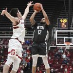 
              Stanford forward Maxime Raynaud (42) defends against Washington State guard Michael Flowers (12) during the second half of an NCAA college basketball game in Stanford, Calif., Thursday, Feb. 3, 2022. (AP Photo/Nic Coury)
            